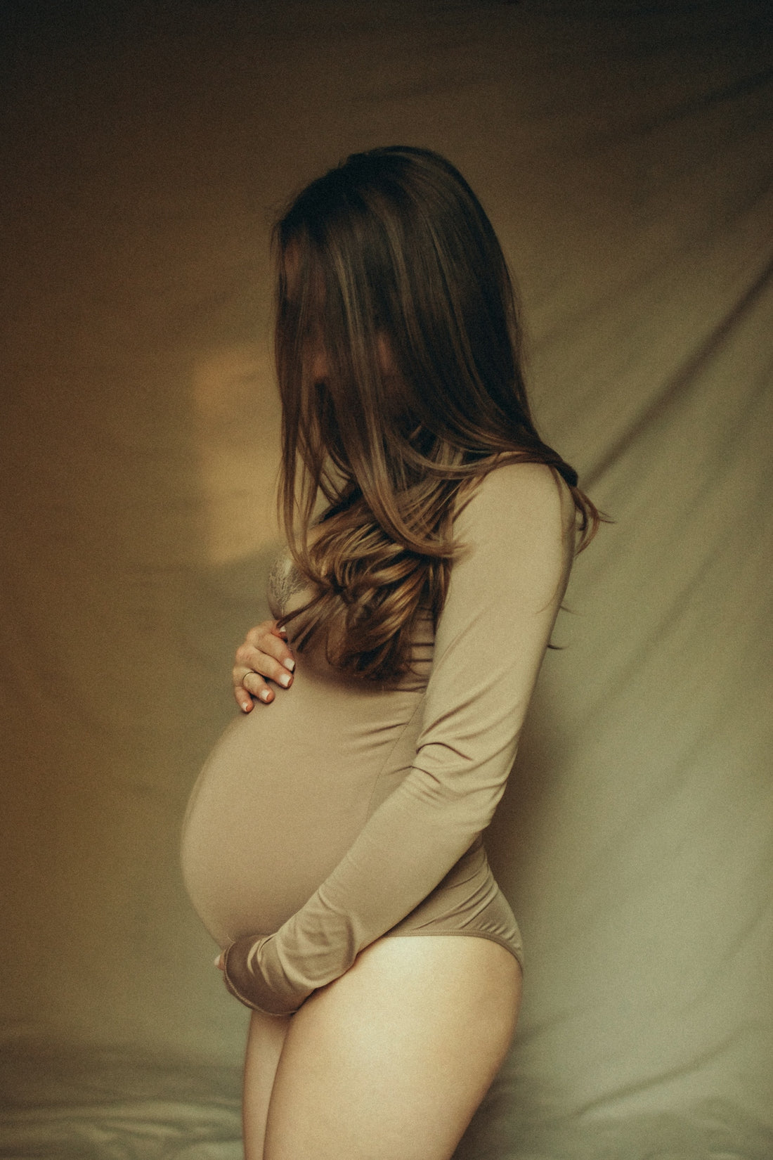 A pregnant woman is posing for a picture