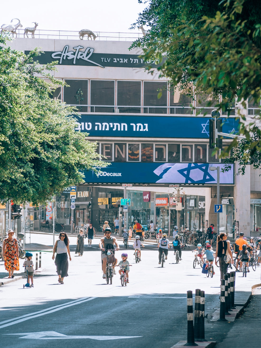 A group of people riding bikes down a street